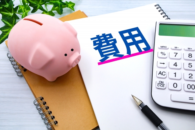 費用と書かれた紙と豚の貯金箱